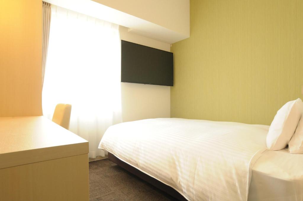 Postel nebo postele na pokoji v ubytování AB Hotel Tokai Otagawa