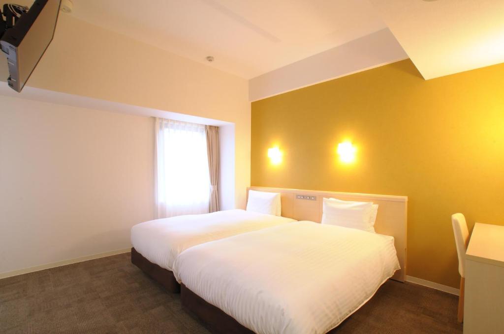 Postel nebo postele na pokoji v ubytování AB Hotel Tokai Otagawa