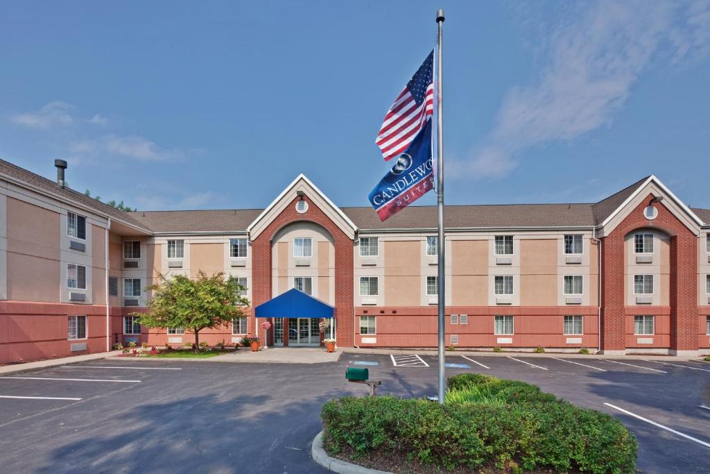 a hotel with a flag in front of a building at Candlewood Suites - East Syracuse - Carrier Circle, an IHG Hotel in East Syracuse