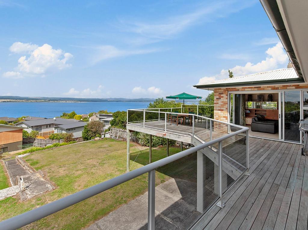 a balcony of a house with a view of the water at Lofty Lakeviews - Acacia Bay Holiday Home in Taupo