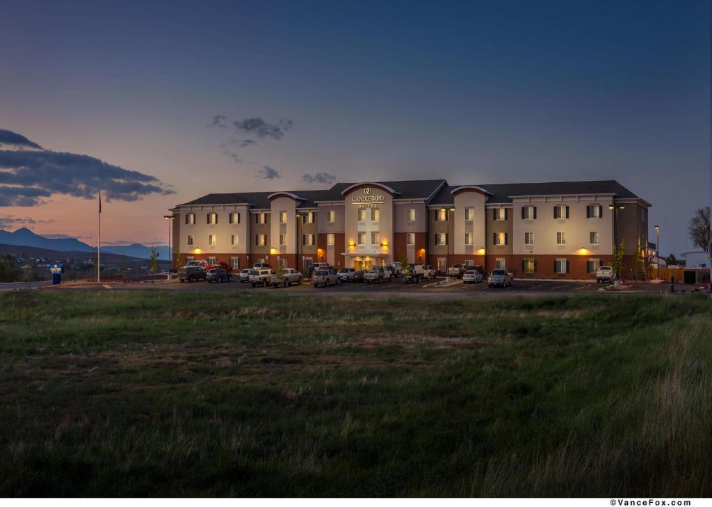 a large building with a field in front of it at Candlewood Suites Winnemucca, an IHG Hotel in Winnemucca