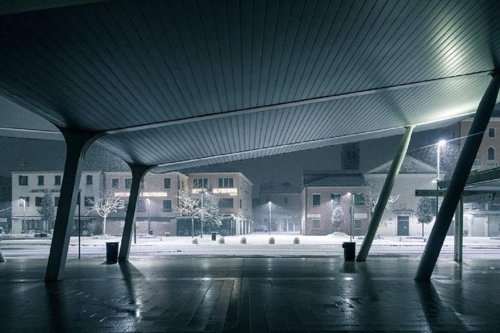 an empty parking lot with a building in the background at Hotel Belvedere in Venice-Lido