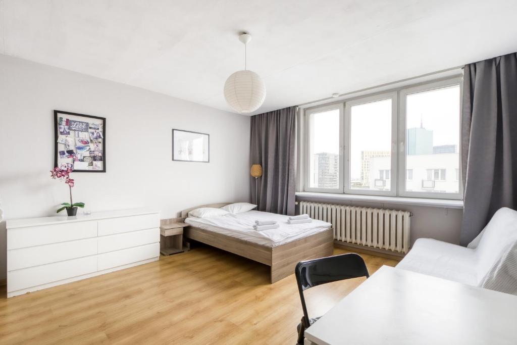 a living room with a bed and a couch at Labo Apartment Niska by Old Town in Warsaw