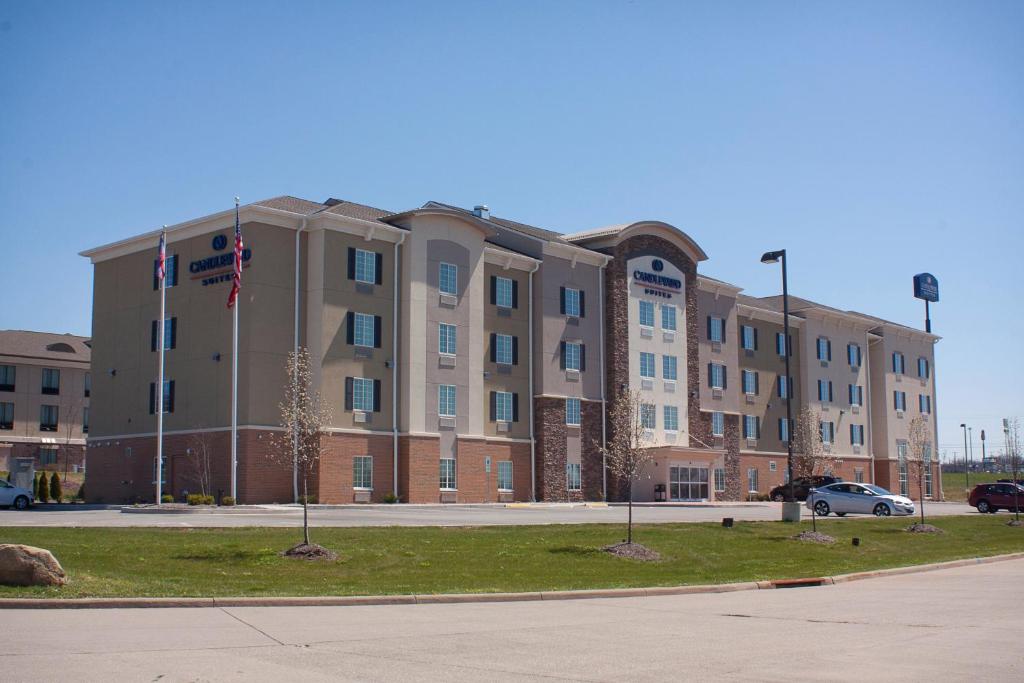 a large building with a flag in front of it at Candlewood Suites Youngstown W - I-80 Niles Area, an IHG Hotel in Austintown