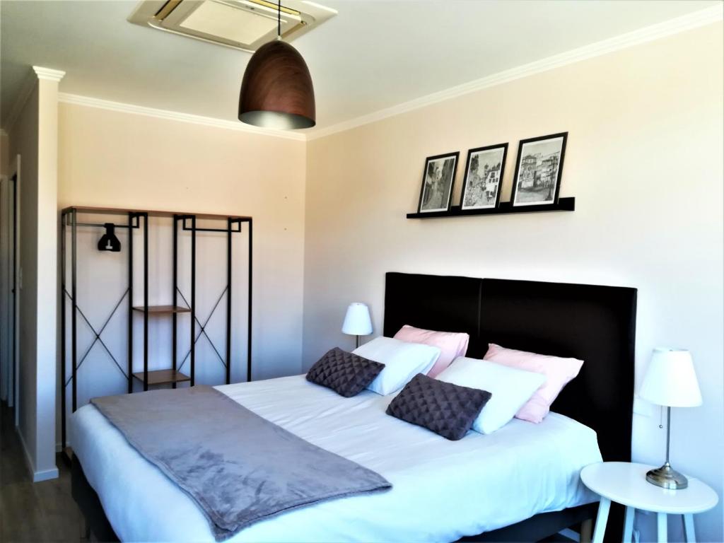 מיטה או מיטות בחדר ב-Porto Ville Touring