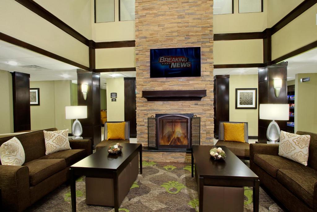 a living room with couches and a fireplace at Staybridge Suites - Odessa - Interstate HWY 20, an IHG Hotel in Odessa