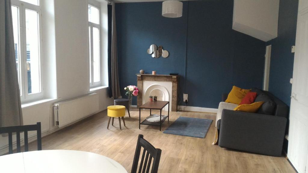 a living room with a couch and a fireplace at Sainte Cécile in Boulogne-sur-Mer