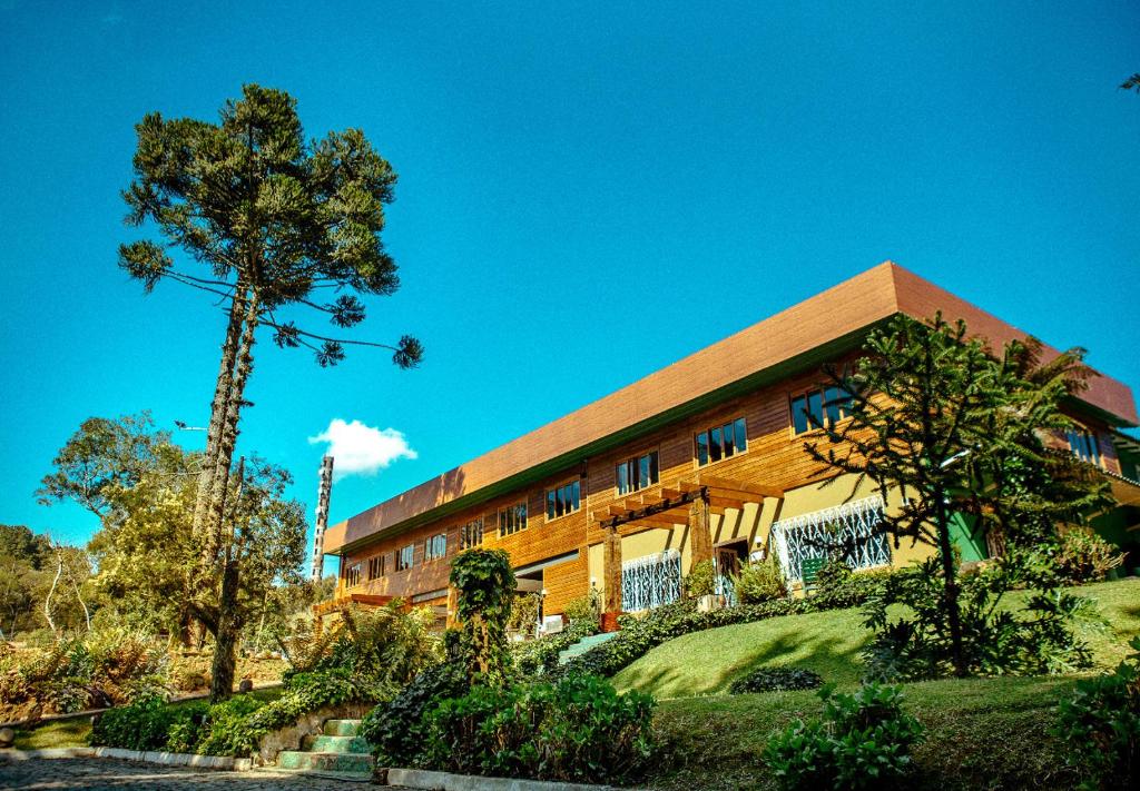 a building with a tree in front of it at Pousada São Chico Eco Village in São Francisco de Paula