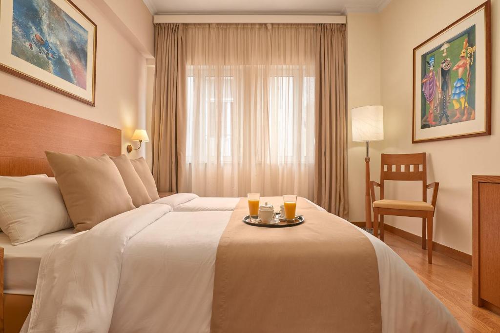 Postel nebo postele na pokoji v ubytování Athos Hotel