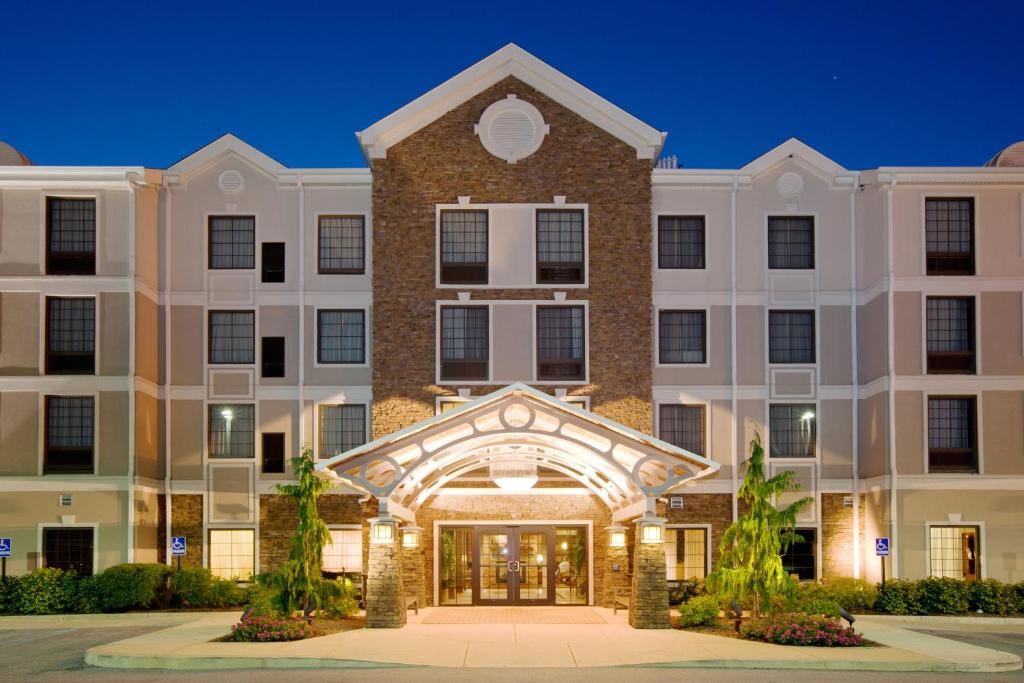 an exterior view of a large building at night at Staybridge Suites Indianapolis-Airport, an IHG Hotel in Plainfield