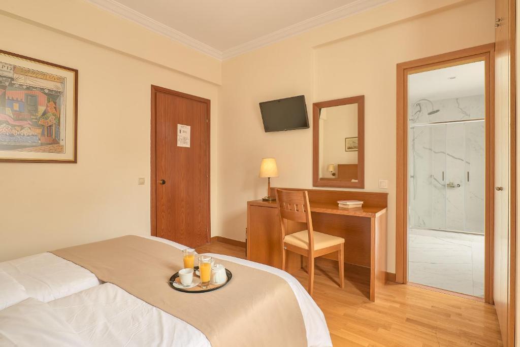 Postel nebo postele na pokoji v ubytování Athos Hotel