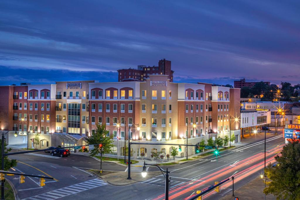 a large building in a city at night at Staybridge Suites Montgomery - Downtown, an IHG Hotel in Montgomery