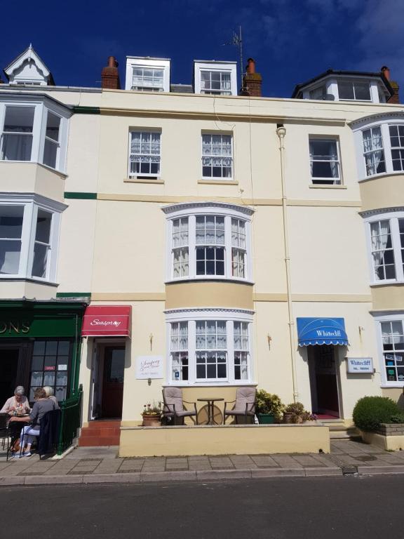 a large white building with a table in front of it at Seaspray Guest House in Weymouth