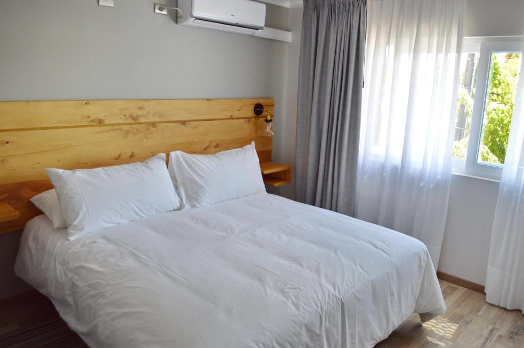 Postel nebo postele na pokoji v ubytování Hotel Cinco Tierras
