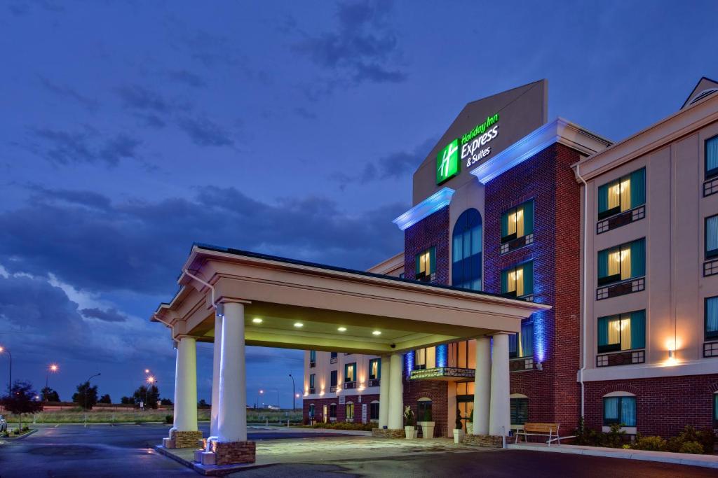 a hotel building with a lit up sign on it at Holiday Inn Express & Suites Medicine Hat, an IHG Hotel in Medicine Hat