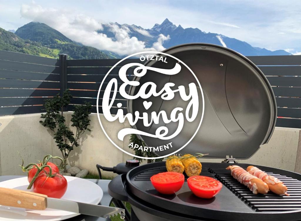 a grill with a sign that reads easy warming with vegetables at Easy Living Apartment Ötztal in Sautens