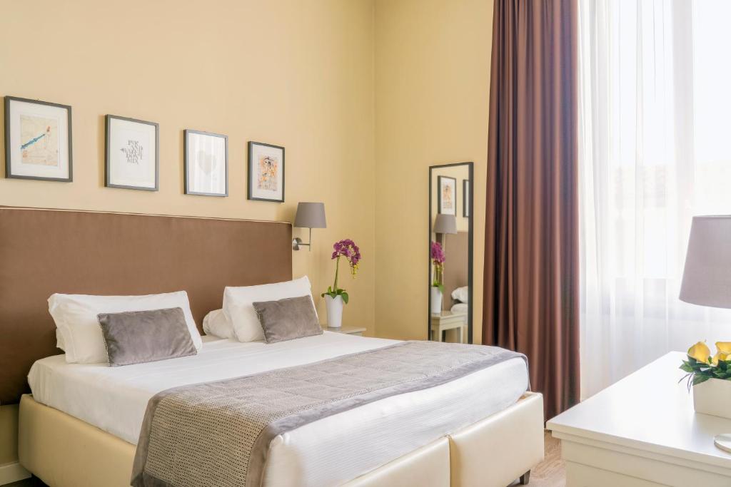 a hotel room with two beds and a window at Dedo Boutique Hotel in Florence