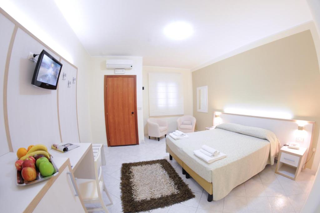a bedroom with a bed and a table with fruit on it at Hotel Residence Nemo in Brindisi