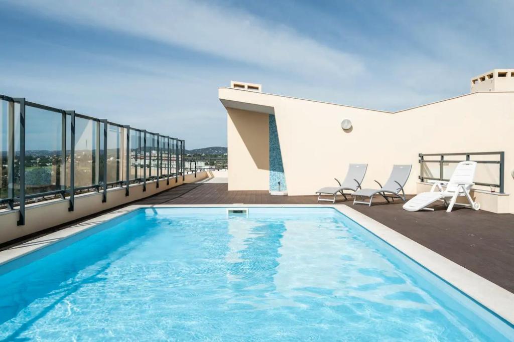 a swimming pool on the roof of a building at OCEANVIEW Luxury Amazing Views and Pool in Olhão