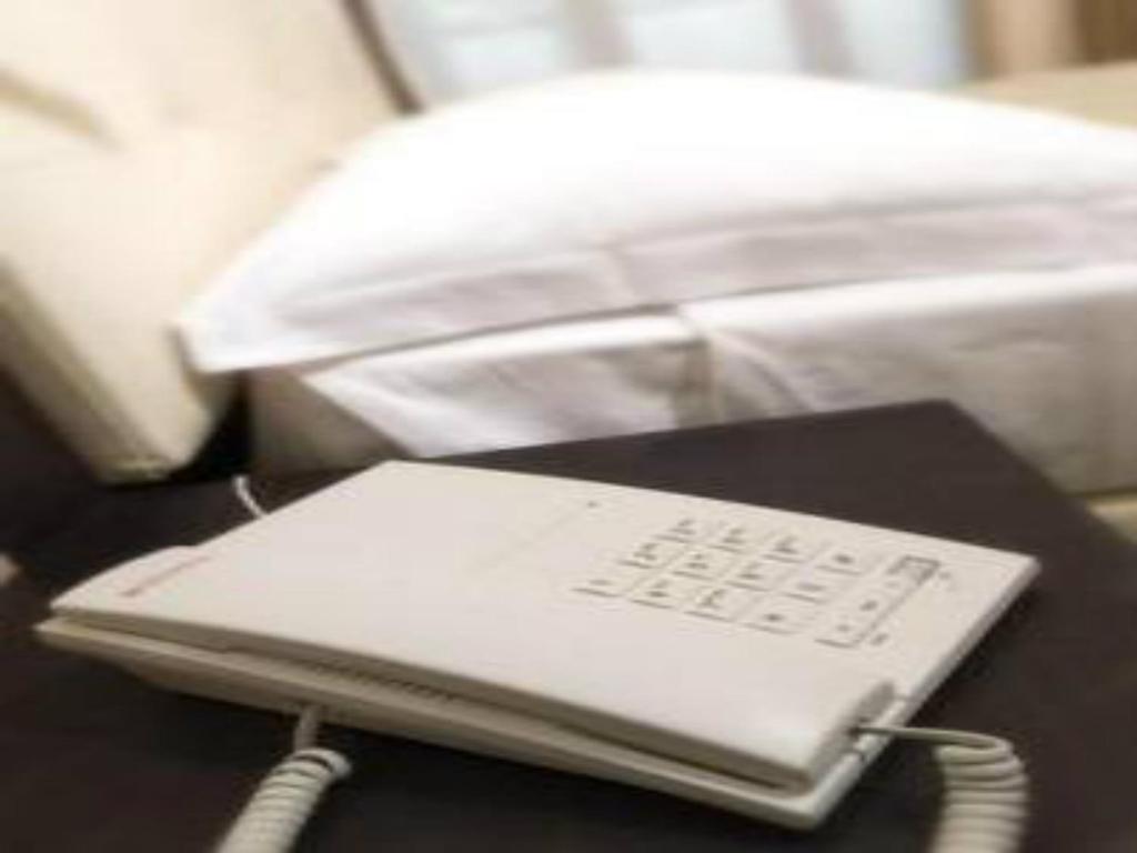 Postel nebo postele na pokoji v ubytování Suite Hotel Elite