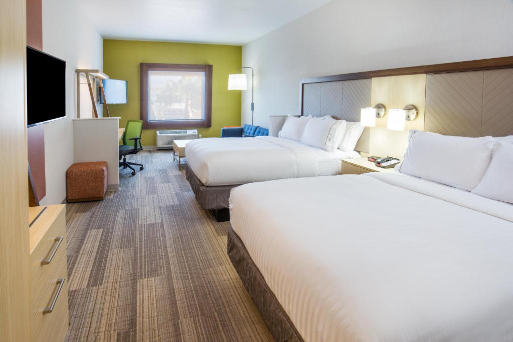 a hotel room with two beds and a television at Holiday Inn Express & Suites Pahrump, an IHG Hotel in Pahrump