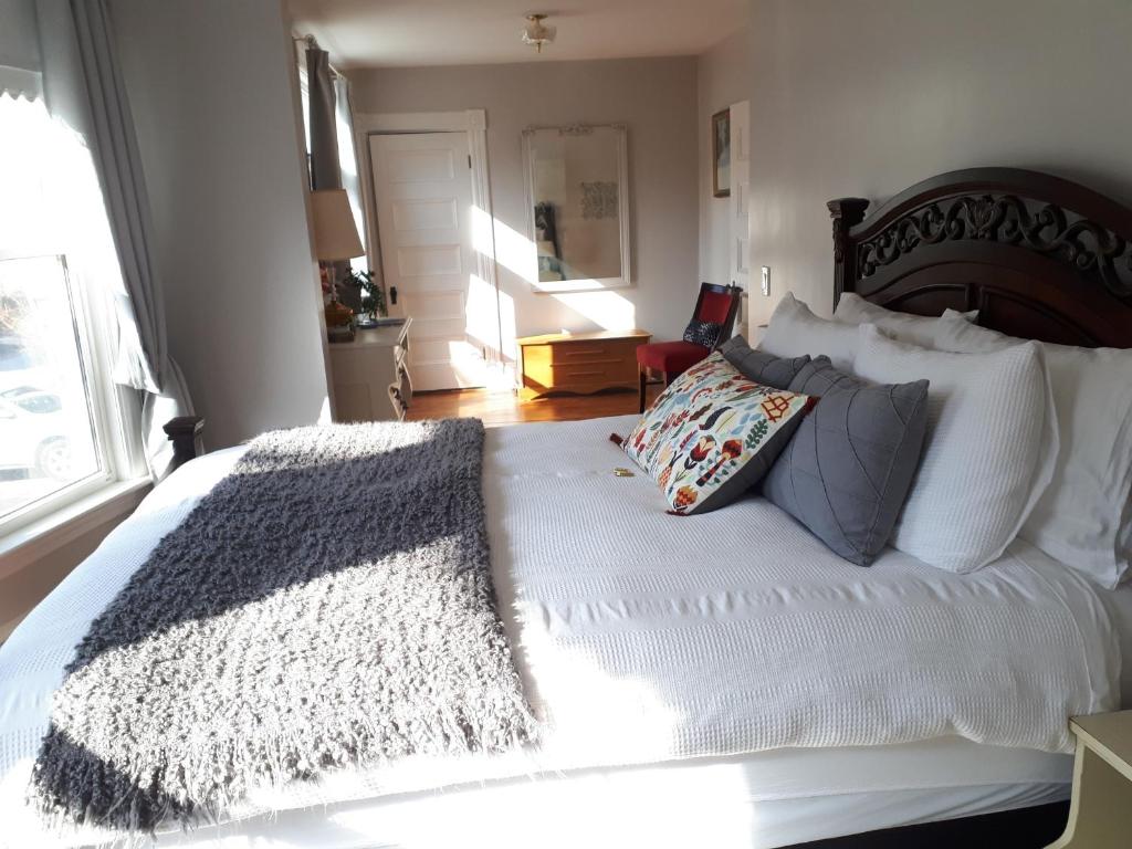 a bedroom with a large white bed with pillows at Hillside Landing B&B in Digby