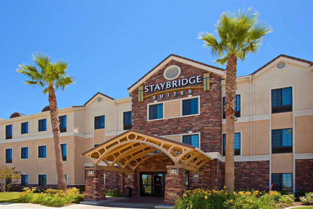 a rendering of a hotel with palm trees at Staybridge Suites Palmdale, an IHG Hotel in Palmdale