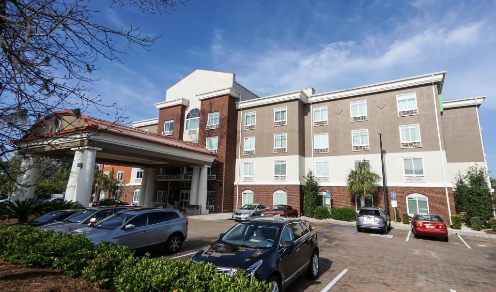 a building with cars parked in a parking lot at Holiday Inn Express Hotel & Suites Savannah Midtown, an IHG Hotel in Savannah