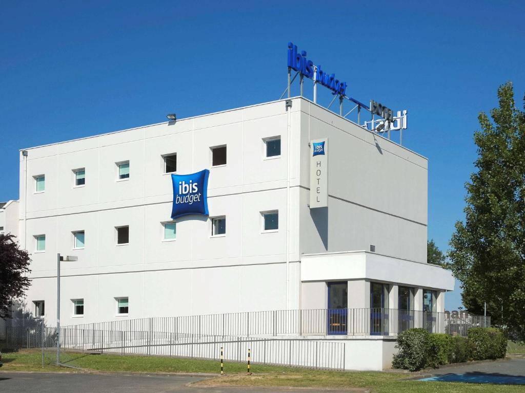 a white building with a blue sign on it at ibis budget Poitiers Sud in Poitiers