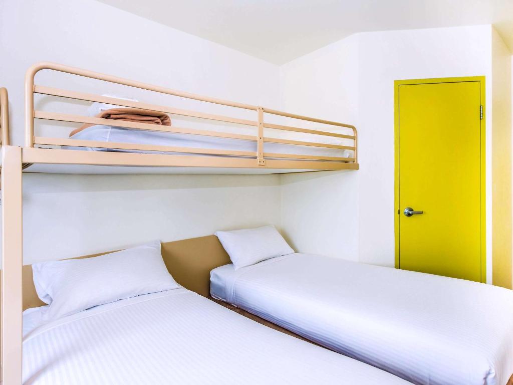 Postel nebo postele na pokoji v ubytování ibis Budget Coffs Harbour