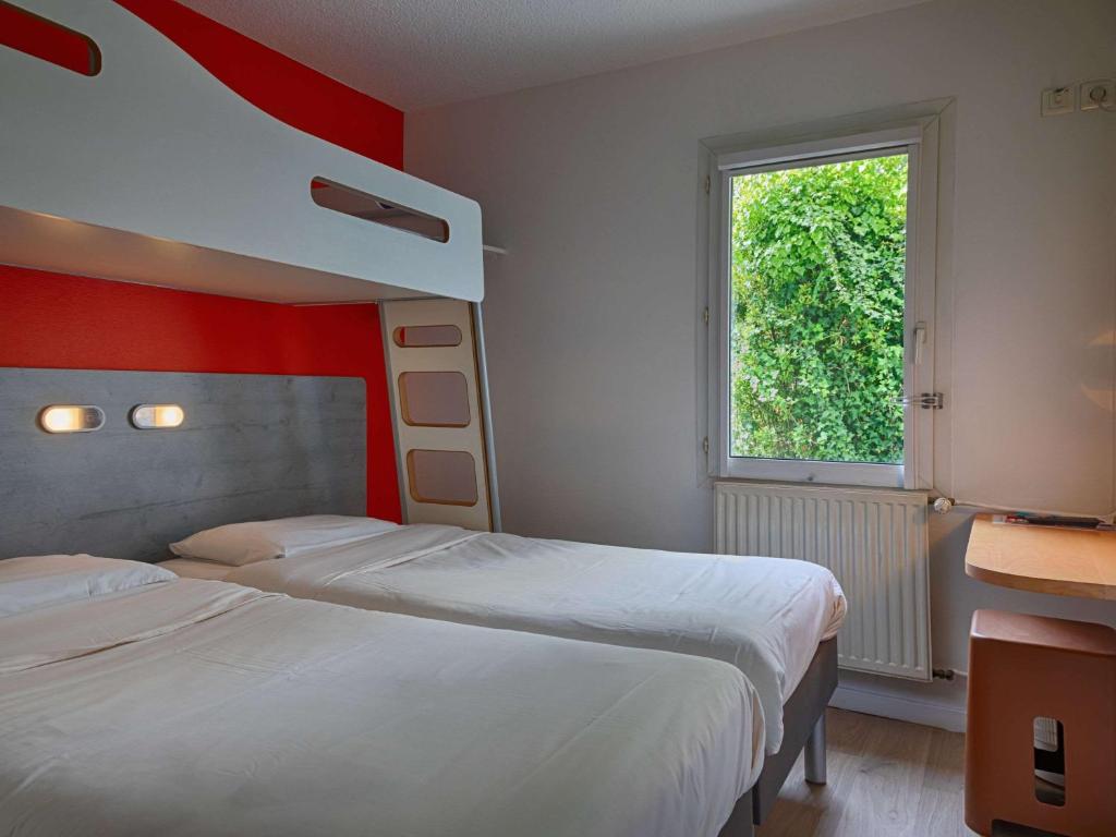 Postel nebo postele na pokoji v ubytování ibis budget Redon
