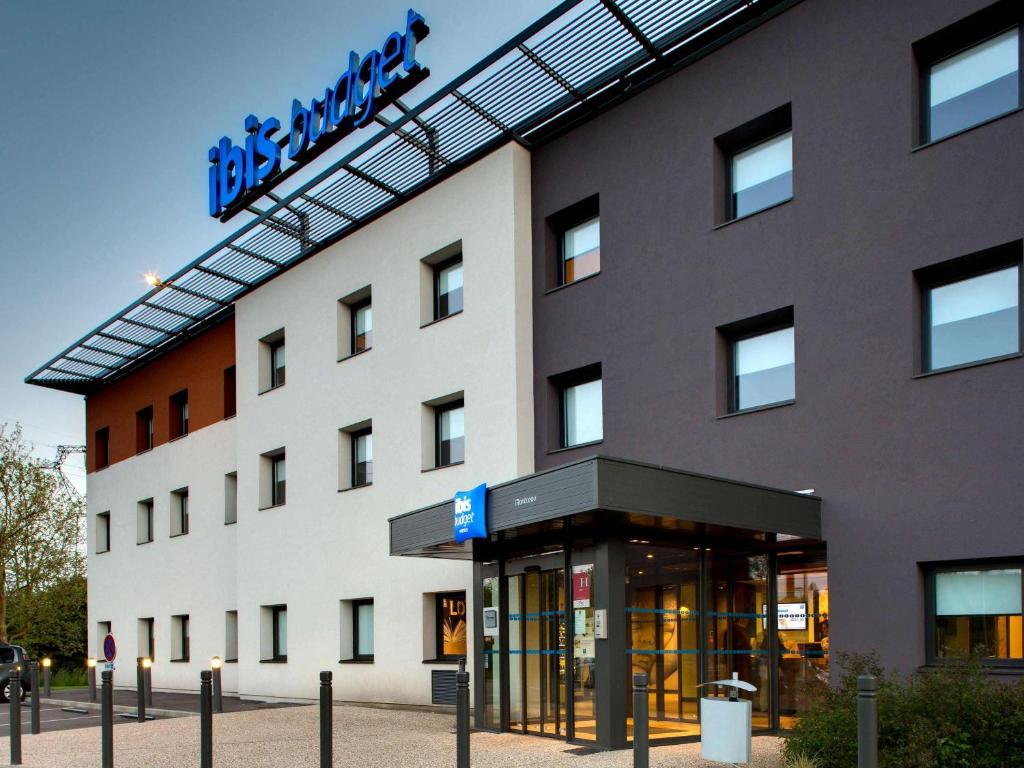 a building with a sign on the side of it at ibis budget Montceau les Mines in Montceau-les-Mines