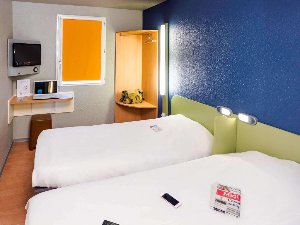 Postel nebo postele na pokoji v ubytování ibis budget Sète centre