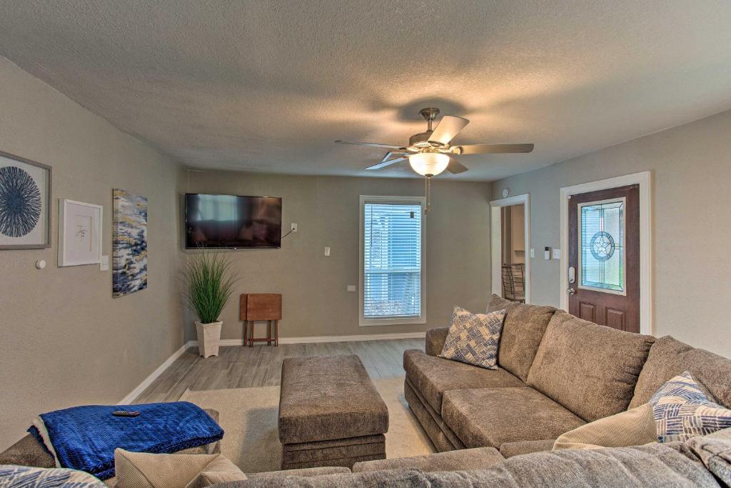 a living room with a couch and a ceiling fan at Family Home with Yard Less Than 1 Mi to Cowboys Stadium in Arlington