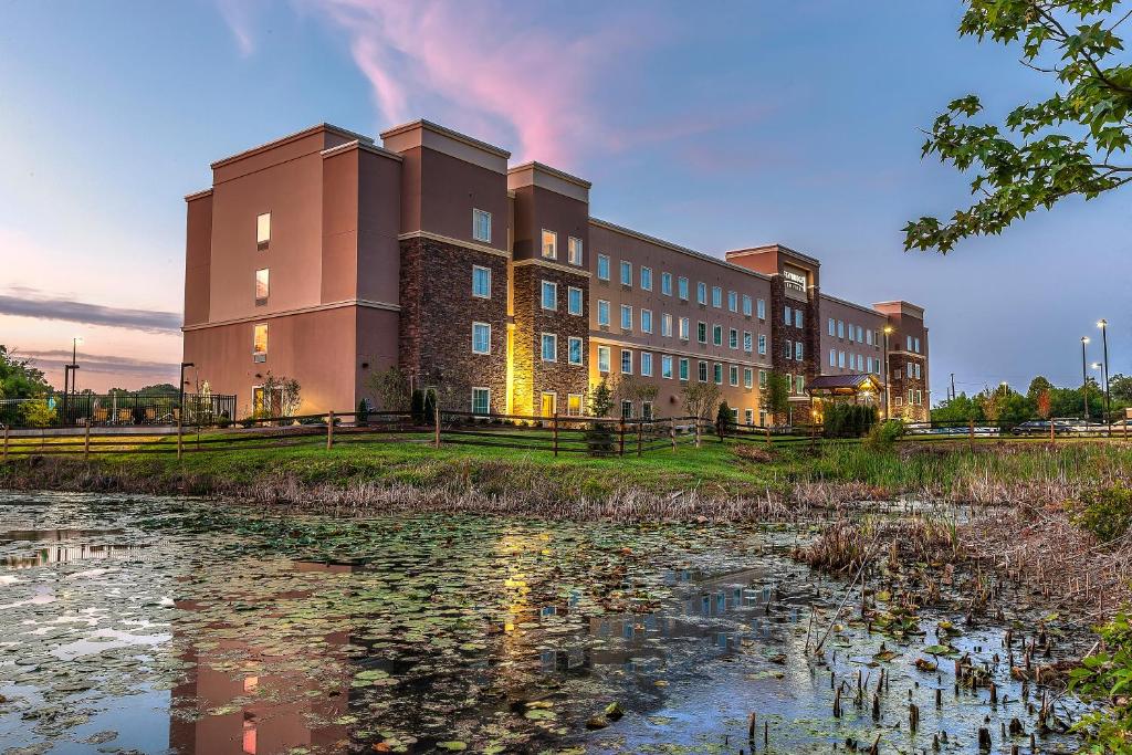 a large building with a pond in front of it at Staybridge Suites Knoxville West, an IHG Hotel in Knoxville