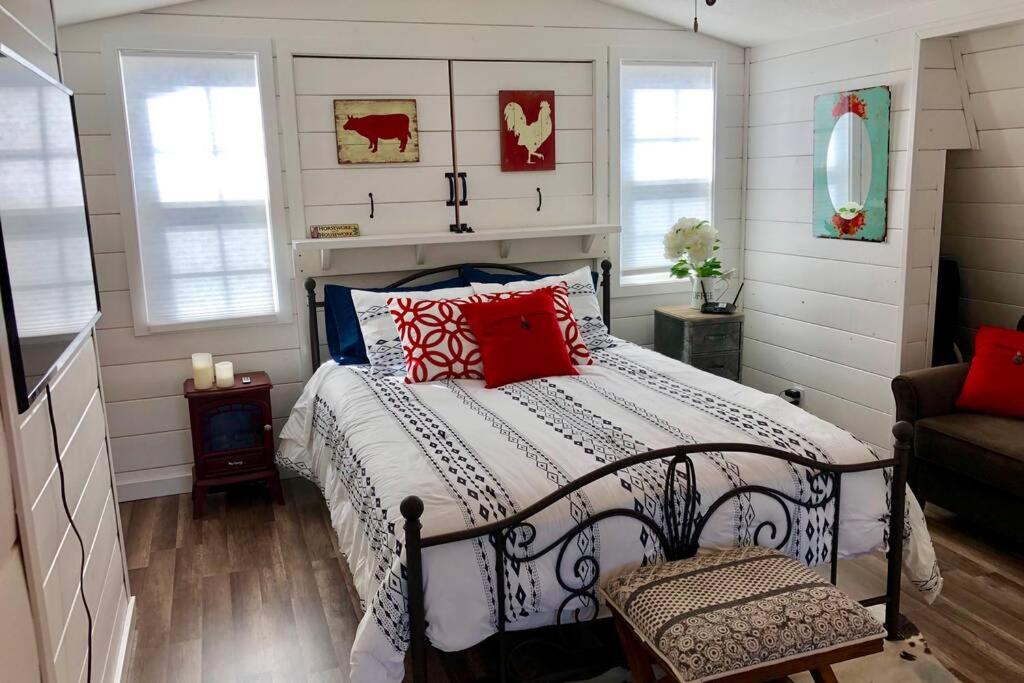 a bedroom with a bed with red and blue pillows at Amazing Loft on Horse Ranch in Pilot Hill