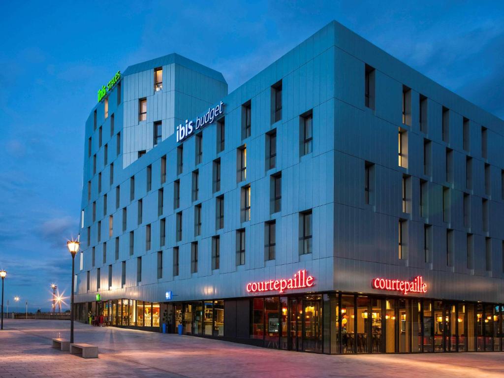 a large blue building with a sign on it at Ibis Budget Mulhouse Centre Gare in Mulhouse