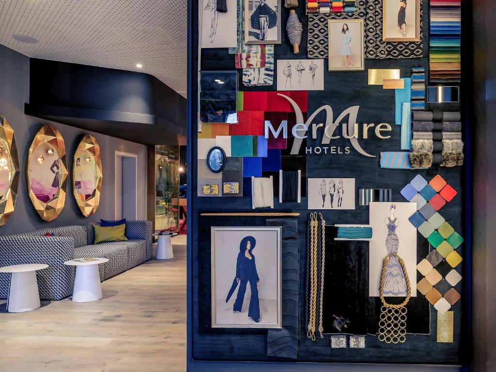 a room with a wall covered in pictures and items at Mercure Berlin Wittenbergplatz in Berlin