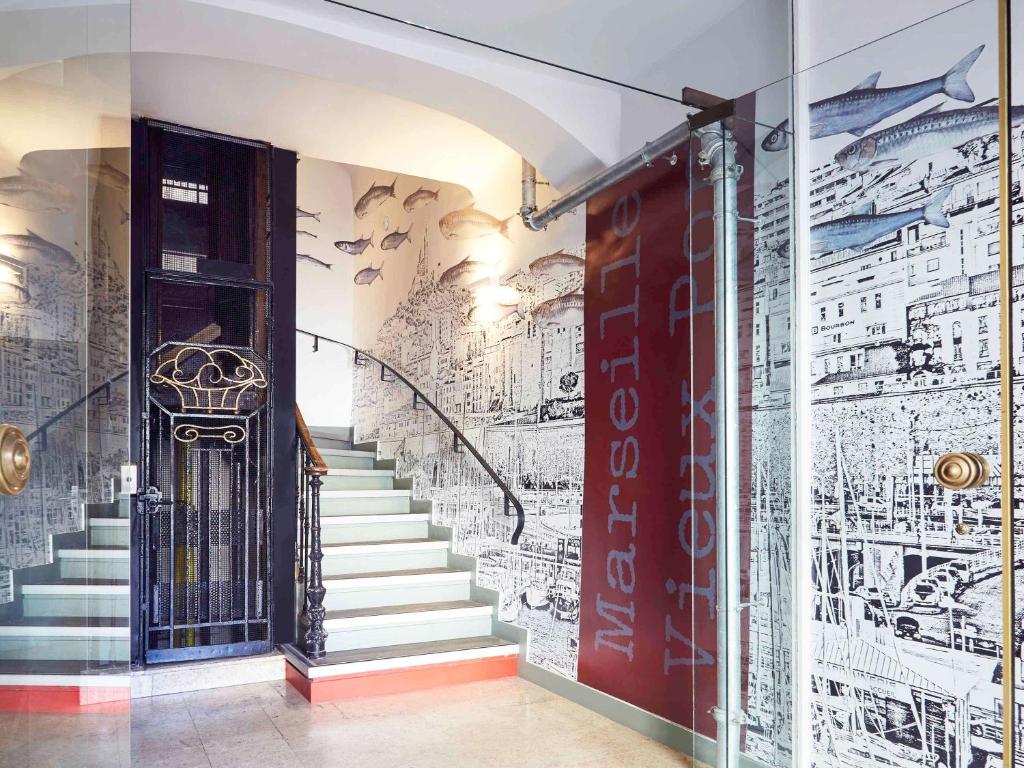 a hallway with stairs and a wall covered in graffiti at ibis Styles Marseille Vieux Port in Marseille