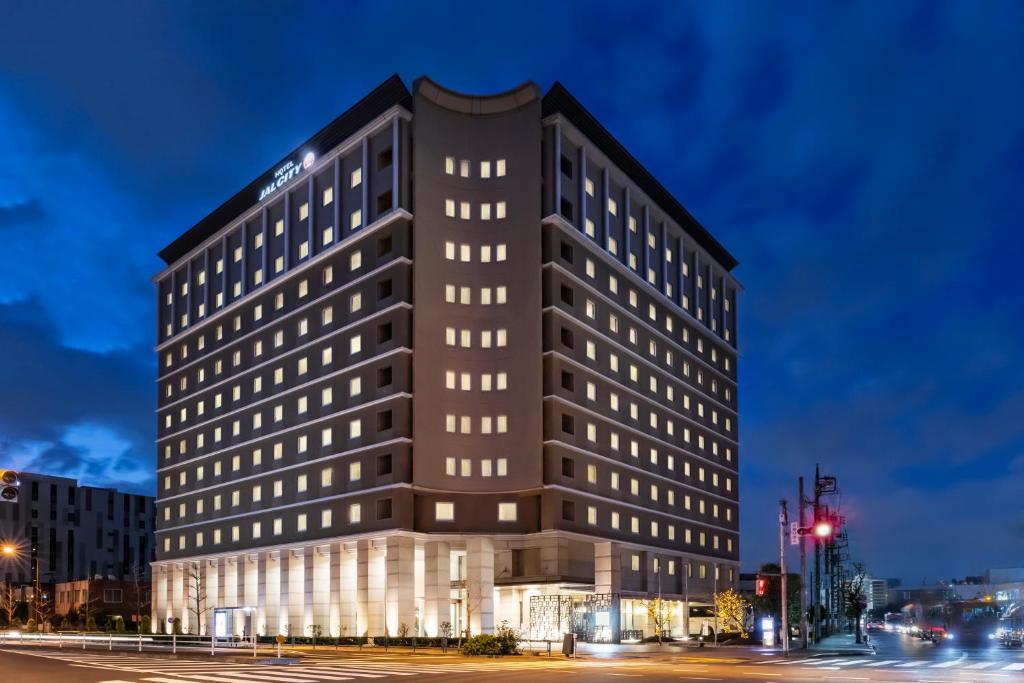 a tall black building with many windows at night at Hotel JAL City Haneda Tokyo in Tokyo