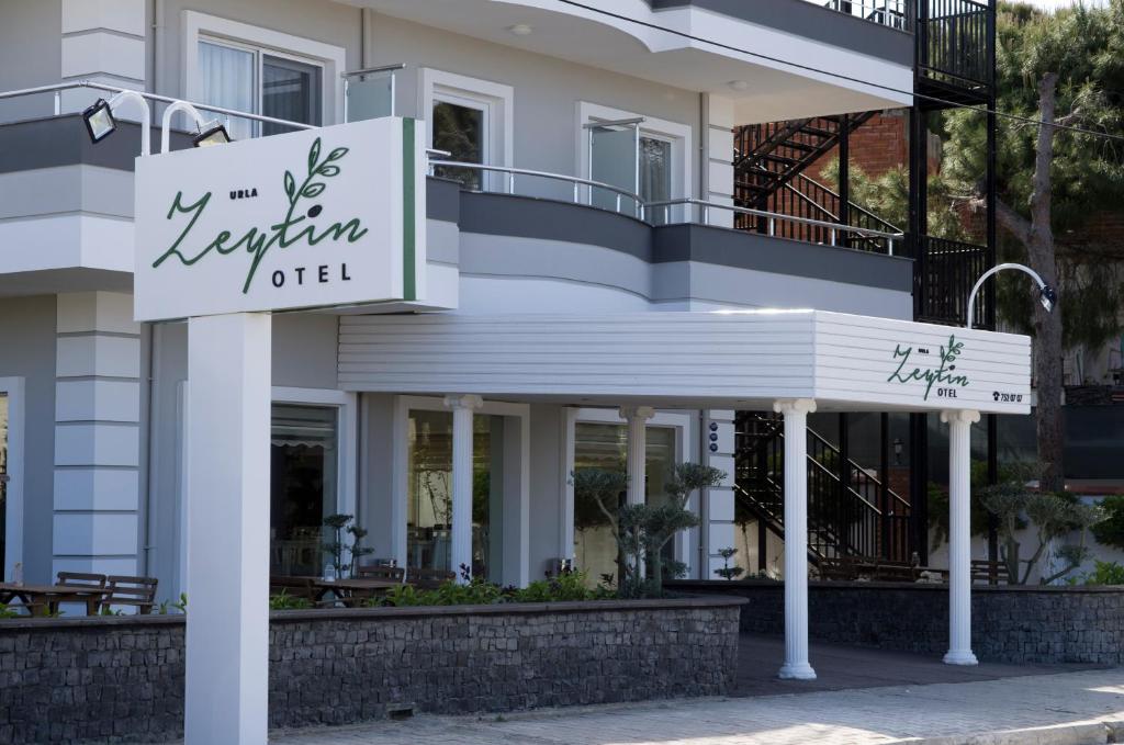 a hotel sign in front of a building at Urla Zeytin Hotel in Urla