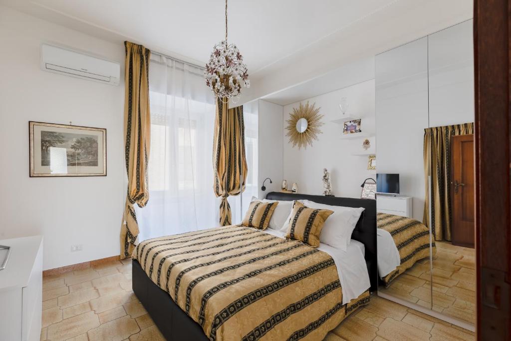 - une chambre avec un lit et un lustre dans l'établissement My Home in San Pietro, à Rome
