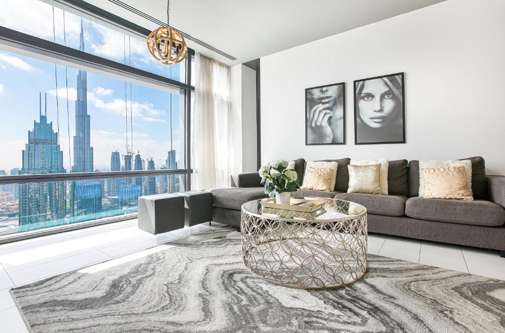 a living room with a couch and a large window at 1 Bed Burj Khalifa View Index Tower DIFC in Dubai