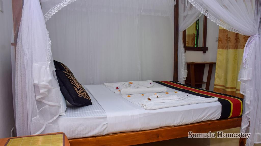 Postel nebo postele na pokoji v ubytování Sumudu Homestay