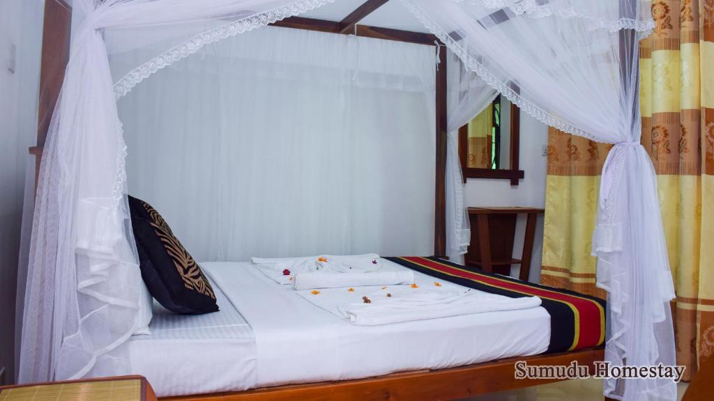 Postel nebo postele na pokoji v ubytování Sumudu Homestay