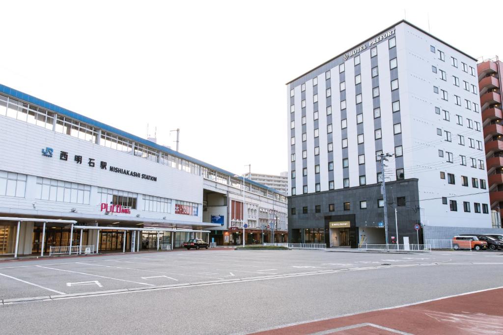 an empty street in a city with tall buildings at Hotel Prefort Nishiakashi in Akashi