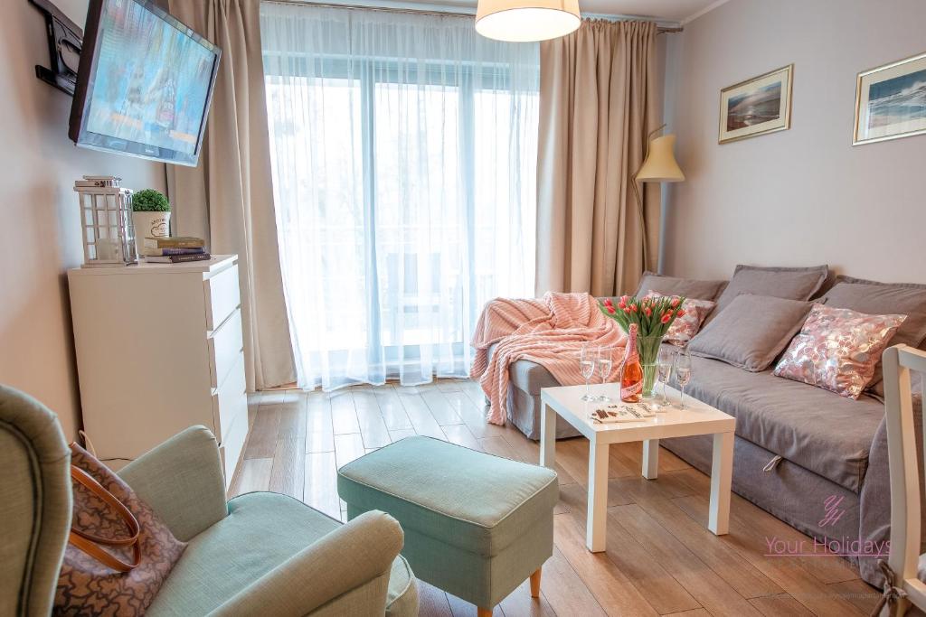 Televízia a/alebo spoločenská miestnosť v ubytovaní Your Holidays Promenada Gwiazd 28