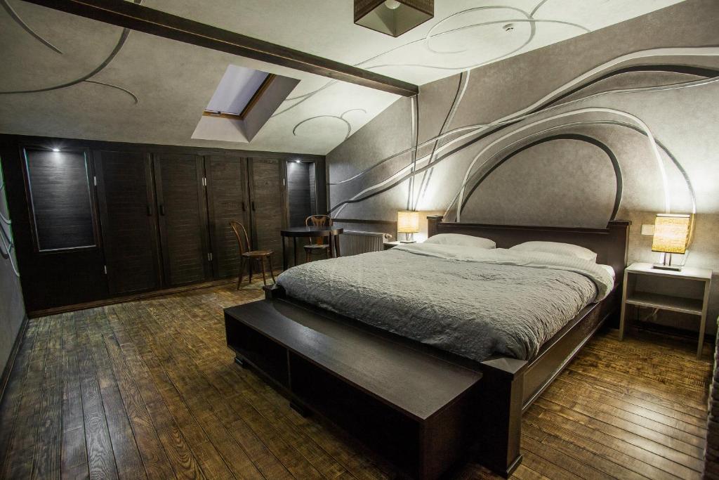 a bedroom with a large bed with an arch above it at Pieno Piano in Rivne
