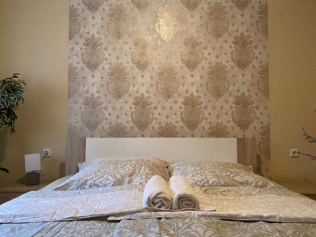 A bed or beds in a room at Virág Vendégház