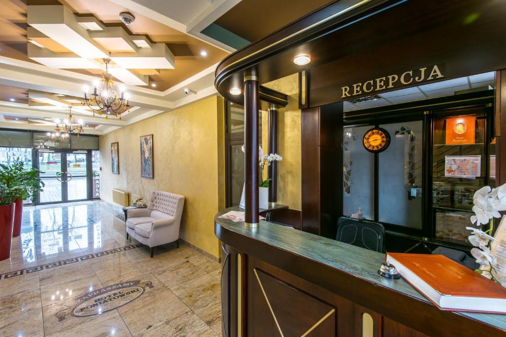 a lobby with a reception desk in a hotel at Hotel Poniatowski in Radom